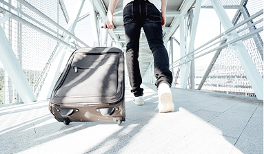 Traveler pulling suitcase at airport